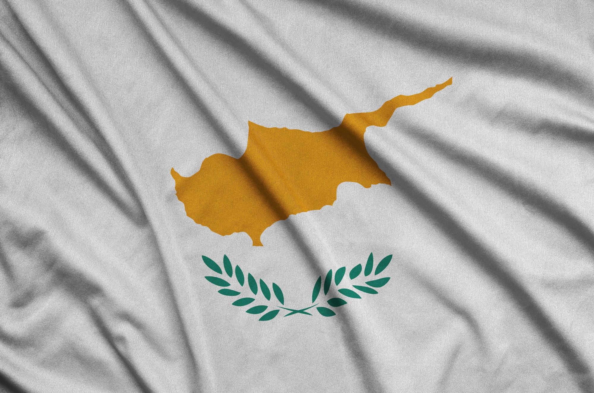 Cyprus flag is depicted on a sports cloth fabric with many folds. Sport team waving banner